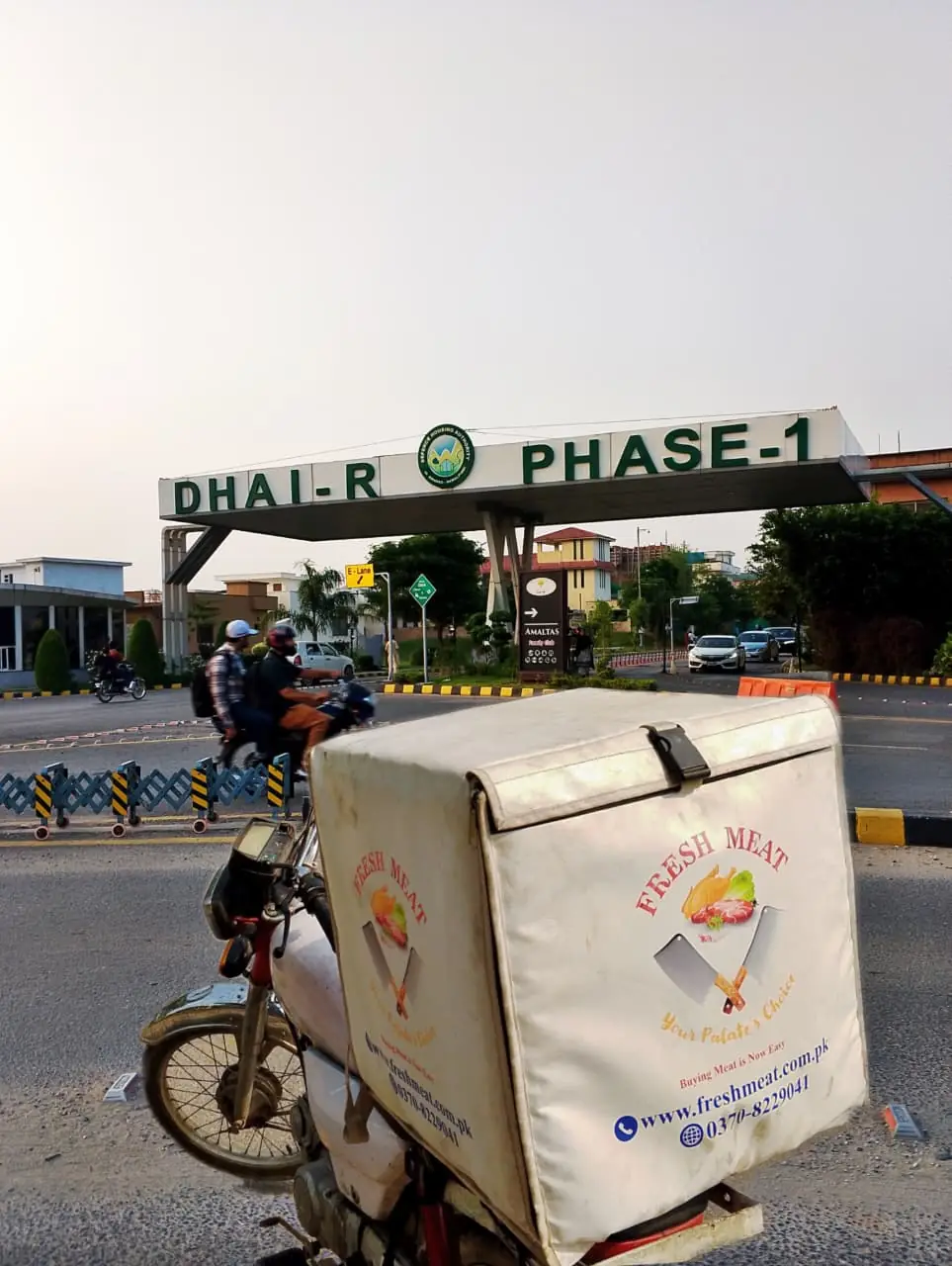 Fresh Meat Shop delivery bike at the DHA Phase 1 gate, Islamabad