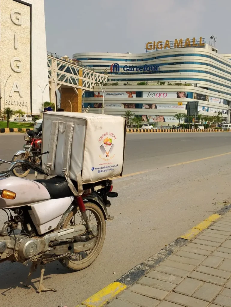 Fresh Meat Shop delivery bike near Giga Mall, DHA 2 Islamabad