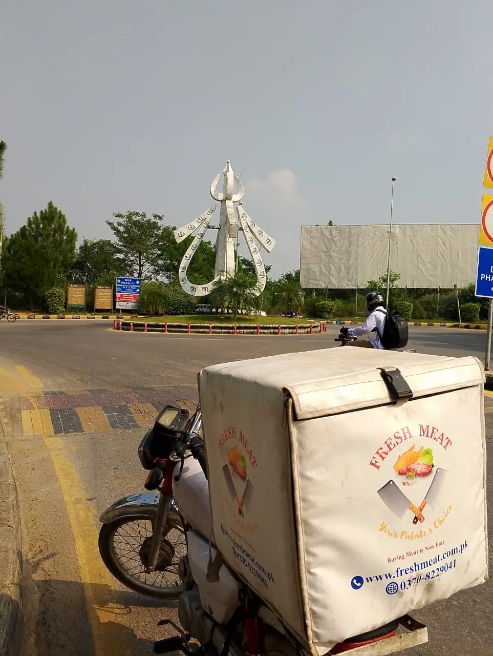 Fresh Meat Shop delivery bike at Allah Hu Chowk, Intellectual Village