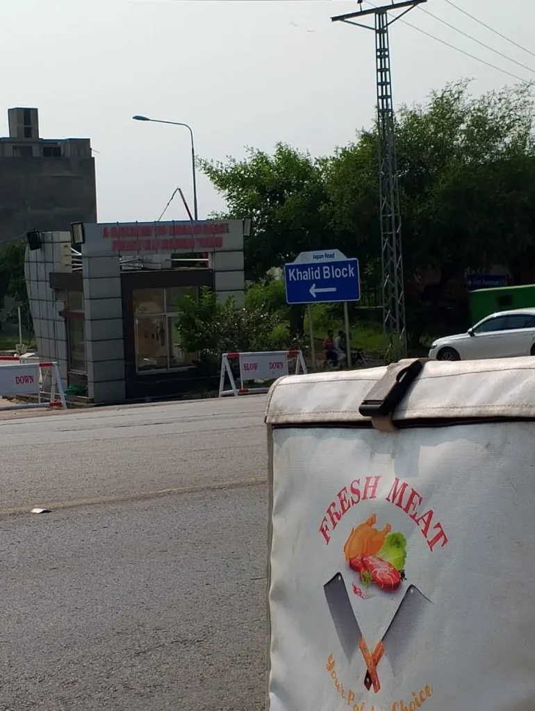 Fresh Meat Shop delivery bike at the Khalid Block entrance on Japan Road