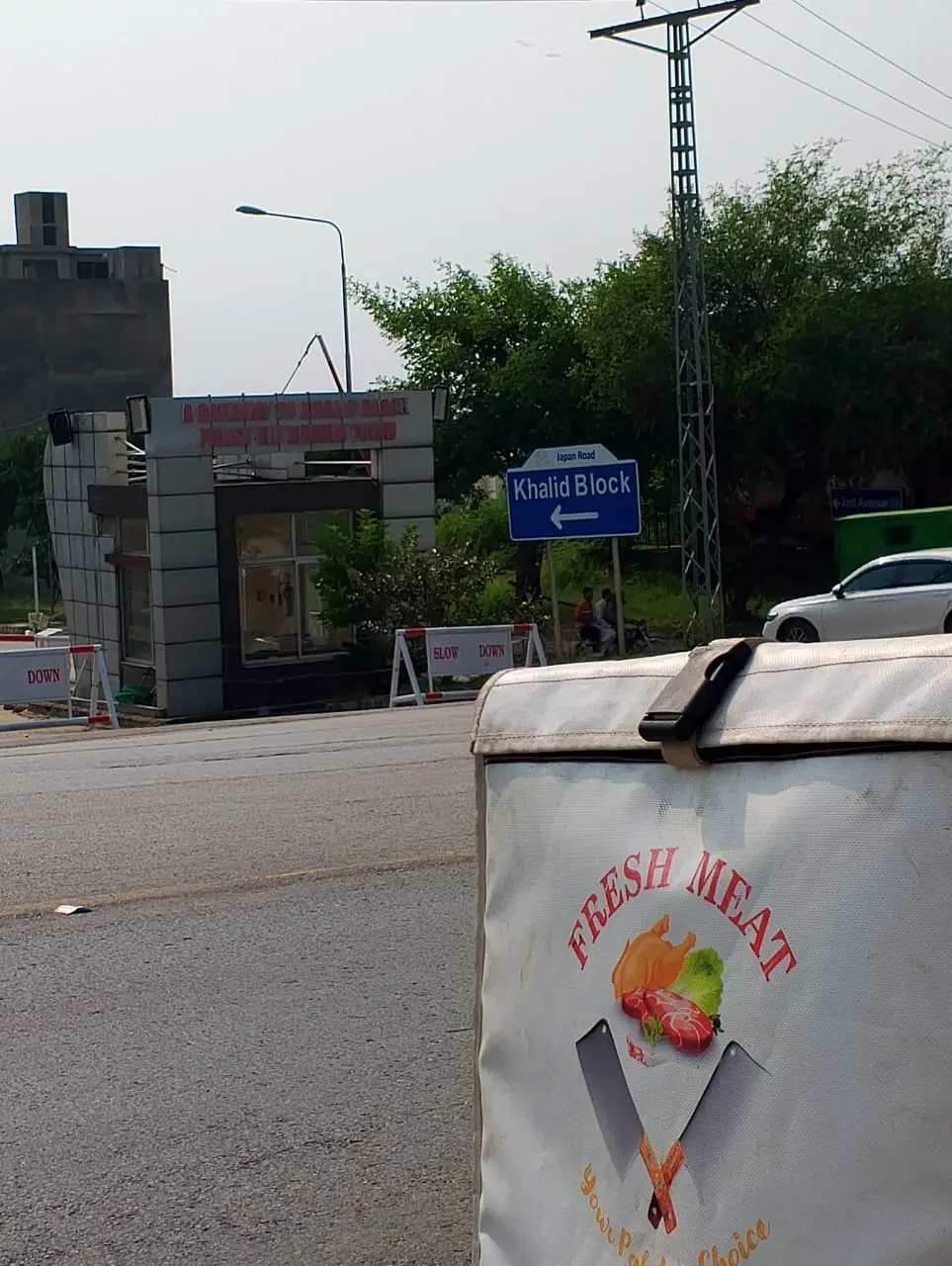 Fresh Meat Shop delivery bike at the Khalid Block entrance on Japan Road